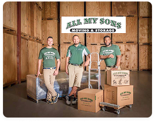 All My Sons Moving & Storage crew members standing with branded boxes in warehouse